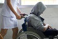 close up young woman nurse push wheelchair for man patient in hospital Royalty Free Stock Photo
