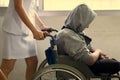 close up young woman nurse push wheelchair for man patient in hospital. medical and care concept. Royalty Free Stock Photo