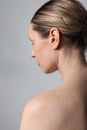 Close-up of young woman with perfect skin and red lips posing indoor. Back view. Royalty Free Stock Photo
