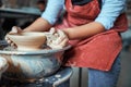 Female ceramist polishing clay bowl in workshop