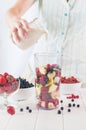 Close up of a young woman prepare to blending fruits with milk Royalty Free Stock Photo