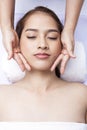 Close-up of young woman receiving facial massage at day spa Royalty Free Stock Photo