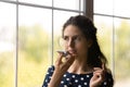 Close up young woman recording audio voice message, holding smartphone