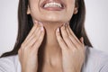 Close up of young woman rubbing her inflamed tonsils, tonsilitis problem, cropped. Woman with thyroid gland problem, touching her