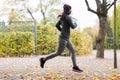 Close up of young woman running in autumn park Royalty Free Stock Photo