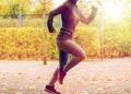 Close up of young woman running in autumn park Royalty Free Stock Photo