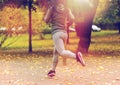 Close up of young woman running in autumn park Royalty Free Stock Photo