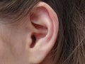 Ear, auricle and earlobe of a woman in close-up Royalty Free Stock Photo