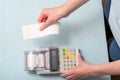 Close-up of a young woman`s hands tearing a check from a cash register after purchasing a product on a market or store Royalty Free Stock Photo