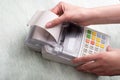 A young woman`s hands tearing a check from a cash register after purchasing a product, entering a discount on a market Royalty Free Stock Photo