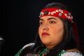 close up of young woman Shaman , curandera, Olmec facilitator, Teotihuacana, Xicalanca - Toltec in black background, with pre-