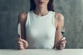 Close up. Young Woman Sitting with Knife and Fork.