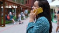 Close up of young woman smiling and speaking on mobile phone. Camera moving around pretty female chatting on cellphone Royalty Free Stock Photo