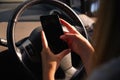 Close Up Of Young Woman Texting On Mobile Phone Whilst Driving Car
