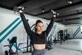 close-up young woman trains muscles on exercise machine in the gym. Royalty Free Stock Photo