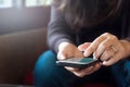 Close up young woman using mobile smart phone at a cafe Royalty Free Stock Photo