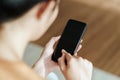 Close up of young woman using smartphone on the sofa. searching, browsing, shoping online, social network Royalty Free Stock Photo