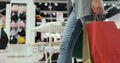 Close up of young woman walks with colorful shopping bags around a shopping mall. Shopping after quarantine. Royalty Free Stock Photo