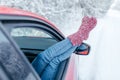 Close-up. Young woman in warm socks resting inside car Royalty Free Stock Photo