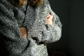 close-up of young woman in warm wool cardigan preparing for cold winter Royalty Free Stock Photo