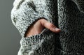 close-up of young woman in warm wool cardigan preparing for cold winter Royalty Free Stock Photo