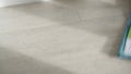 Close up of young woman washing white kitchen floor with special swob, cleaning service