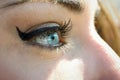 Close-up of young woman's blue eyes with long eyelashes Royalty Free Stock Photo
