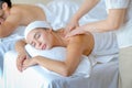 Close up of young woman enjoy with body massage in spa room with day light and the other man lie on bed beside Royalty Free Stock Photo