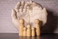 Close up of young women holding people shape male and female doll wooden peg dolls, family day