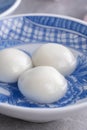 Close up of yuanxiao tangyuan in a bowl on gray table, food for Chinese Lantern Yuanxiao Festival