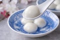 Close up of yuanxiao tangyuan in a bowl on gray table, food for Chinese Lantern Yuanxiao Festival