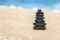 Close-up of Zen Stacked Pebbles on Sandy Beach