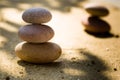Zen stone stacking on sand