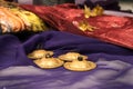 Close-up of zills for bellydancing on a purple veil with arabic cushions Royalty Free Stock Photo