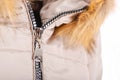 Close up of zipper on beige jacket with fur, winter fashion outfit. Jacket isolated on white background.Close up of zipper on Royalty Free Stock Photo