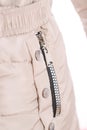 Close up of zipper on beige jacket pocket, winter fashion outfit. Jacket isolated on white background Royalty Free Stock Photo