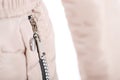 Close up of zipper on beige jacket pocket, winter fashion outfit. Jacket isolated on white background Royalty Free Stock Photo