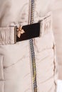 Close up of zipper on beige jacket , winter fashion outfit. Jacket isolated on white background Royalty Free Stock Photo