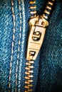 Close up of a zipper over blue denim Royalty Free Stock Photo