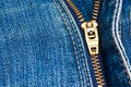 Close up of a zipper over blue denim Royalty Free Stock Photo