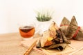 Close up Zongzi or rice dumpling on the wooden table with Chinese tea in Dragon Boat Festival, Asian traditional food Royalty Free Stock Photo