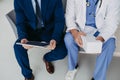 Close upf on legs of pharmaceutical sales representative talking with doctor in medical building, presenting new Royalty Free Stock Photo