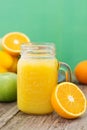 Fruit juice in the glass jar. Green background, wooden table. Fresh vegetables and fruits - avocado, apple, tomatoes. . Healthy, Royalty Free Stock Photo