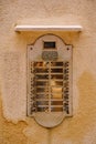 Close-ups of building facades in Venice, Italy. An old vintage intercom and a mailbox on a stone wall. On door where Royalty Free Stock Photo