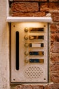 Close-ups of building facades in Venice, Italy. An old vintage intercom and a mailbox on a stone wall. On door where Royalty Free Stock Photo