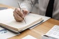 Close-ups of a businessman taking notes in a notebook to record reminders and actions. Concept of note taking Royalty Free Stock Photo