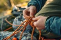 Close-ups of hands tying knots for outdoor activities. Colorful rope.