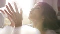 Close upside view of playful attractive young woman blowing off white foam while enjoying luxurious bath. Video. Concept Royalty Free Stock Photo