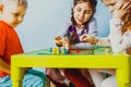 Close view of children faces around table with board game Royalty Free Stock Photo