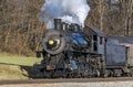 Close View of An Antique Steam Engine Blowing Steam While Traveling Slowly Thru the Countryside